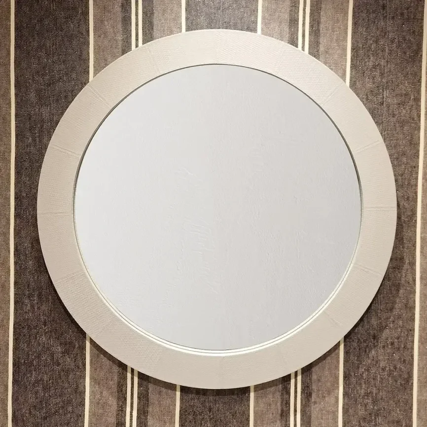 Round Mirror Pumice Woven Leather — Wrapped in premium pumice woven leather, the mirror's frame offers a tactile richness…