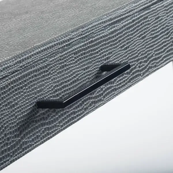 Slide Console Komodo Leather — The linear top sits on a powder-coated frame in black bronze, a sophisticated counterpoint…